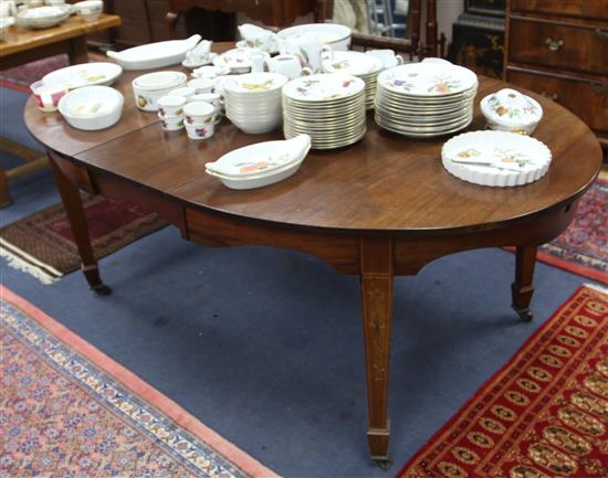 An Edwardian inlaid mahogany oval topped dining table 191cm